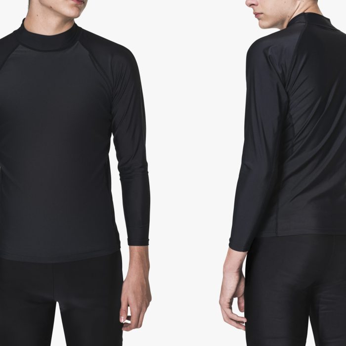 Teenage boy in rash guard and shorts for swimwear fashion shoot rear view